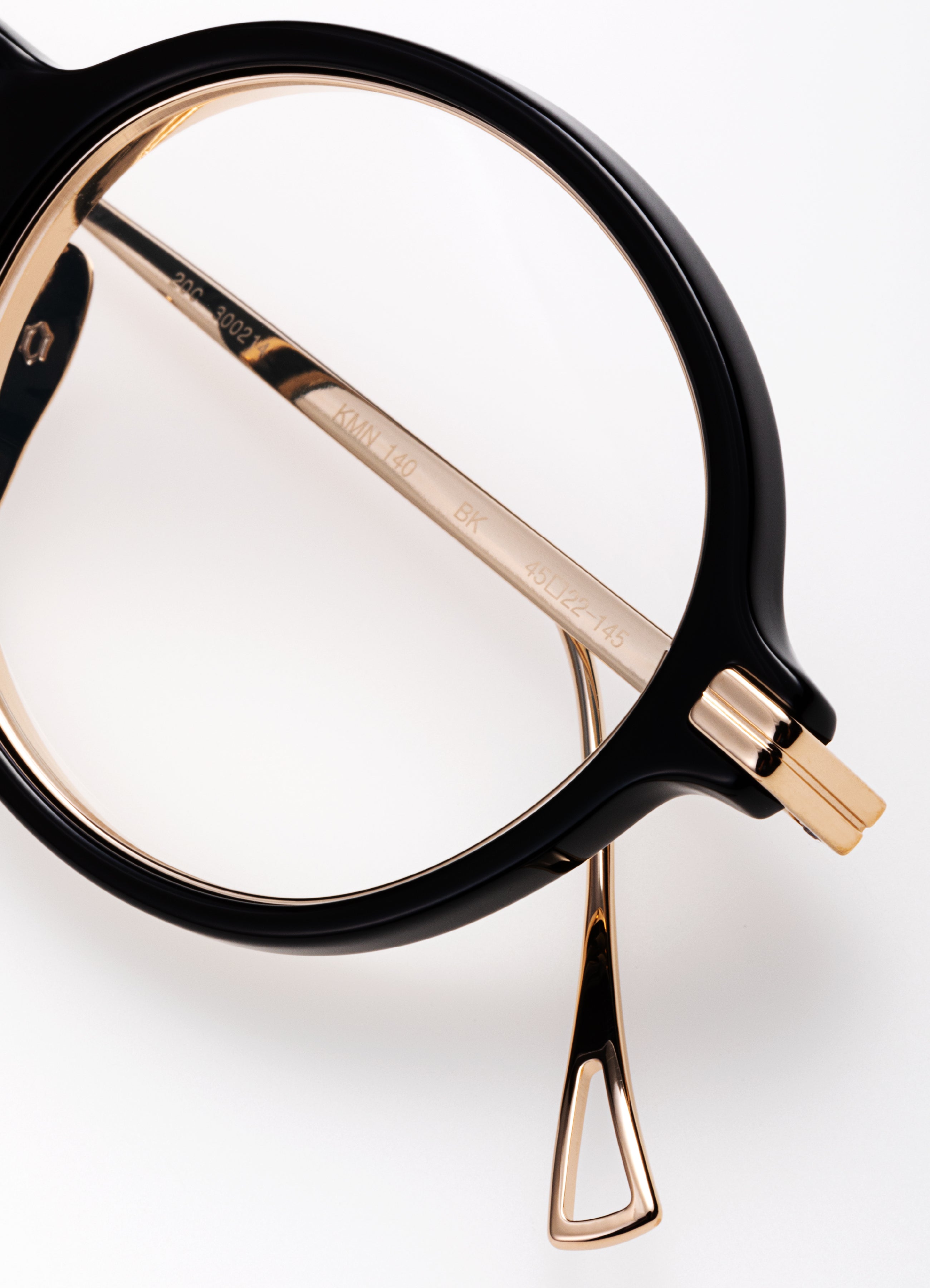 Black and gold eyeglasses on a white background