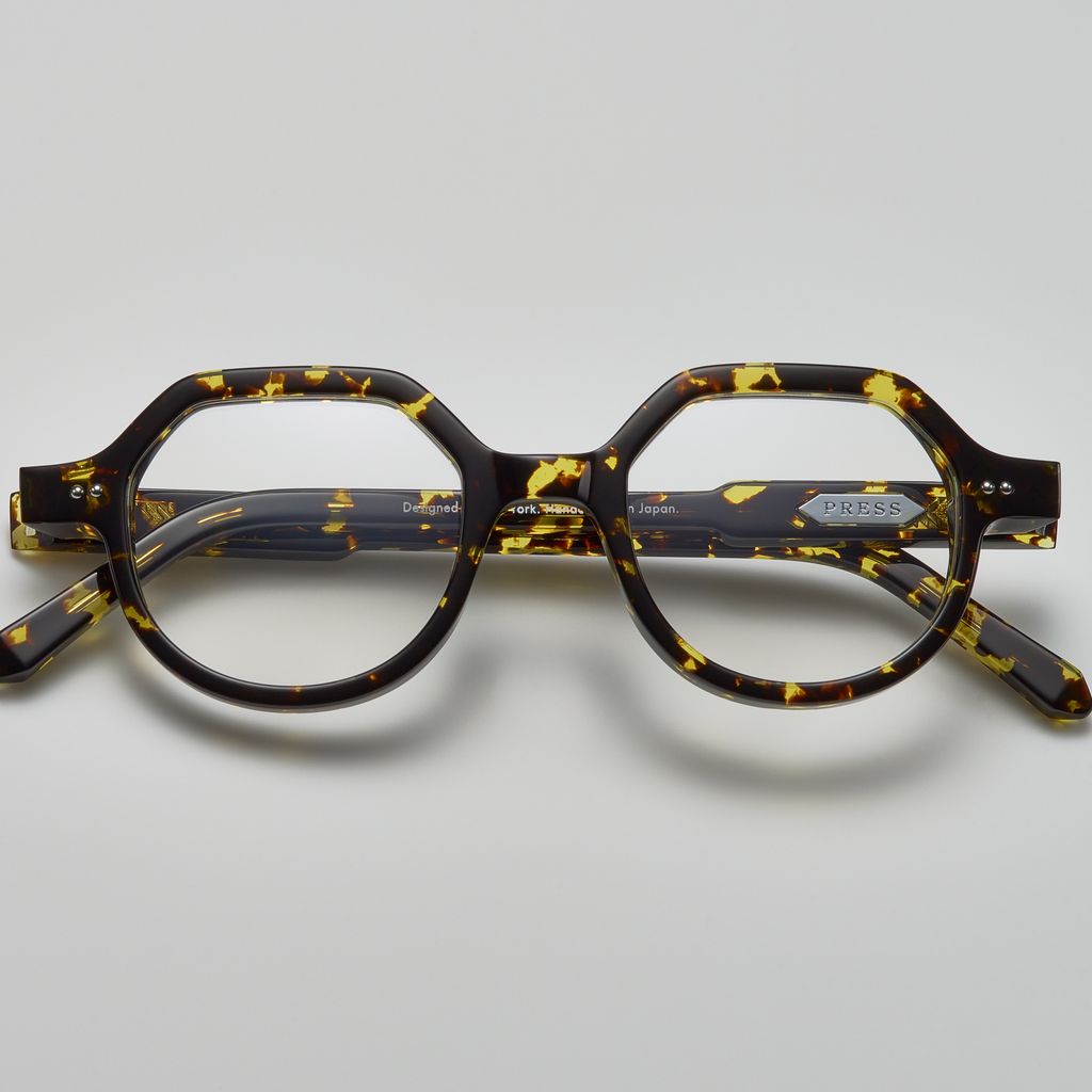 Tortoiseshell acetate eyeglasses with round and subtly geometric frames, featuring the brand name "PRESS" on the temple, by Yosemite Eyewear