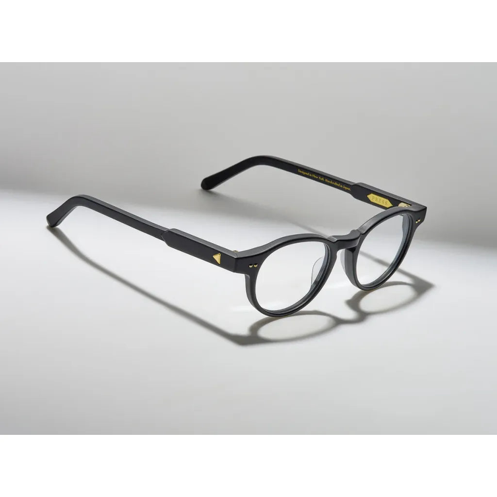 Black eyeglasses on a light gray background