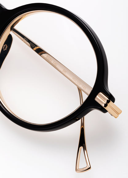 Black and gold eyeglasses on a white background