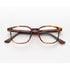 Brown tortoiseshell eyeglasses on a white background