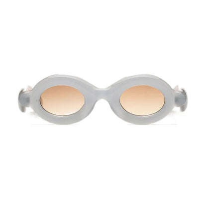 Paloceras Pebble Milky Blue RX sunglasses in milky blue with an oval frame and peach gradient lenses, front view