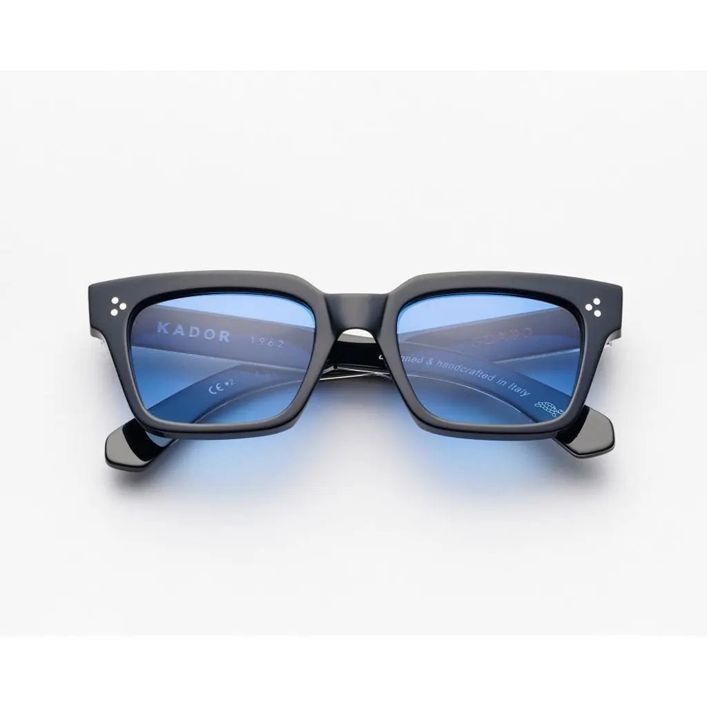 Black sunglasses with blue lenses on a white background kador guapo